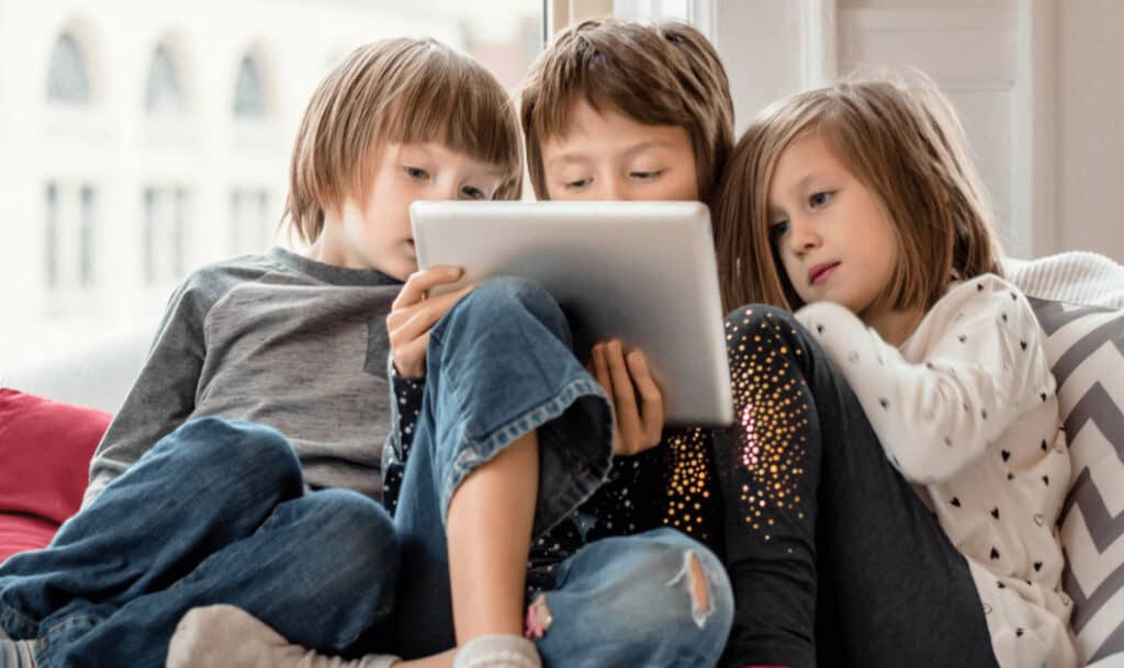 children reading a story on their tablet