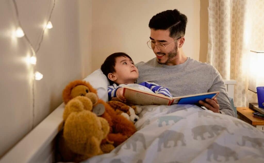 Father reading a bedtime story to his son
